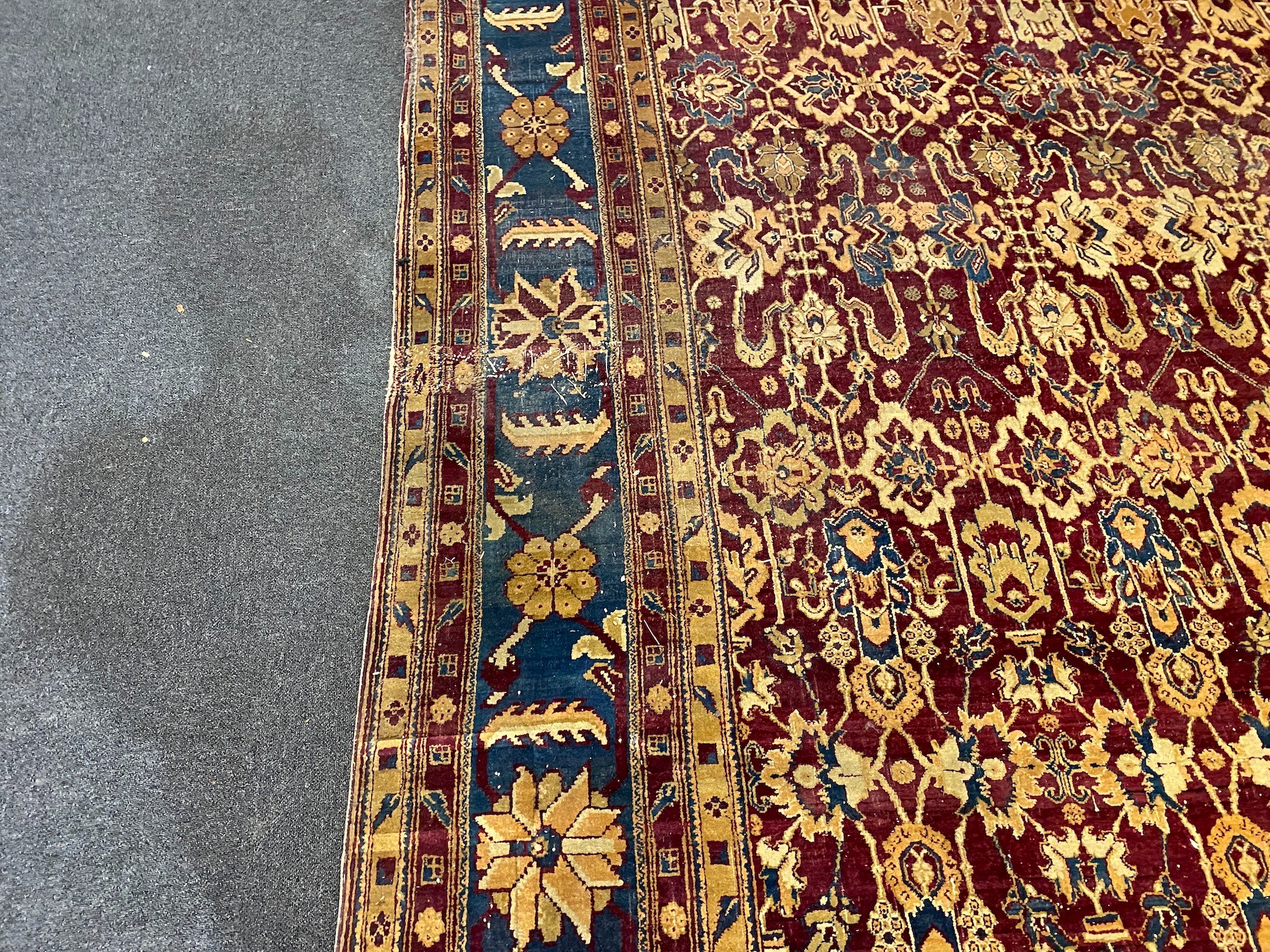 A large Sarouk purple ground carpet, approx. 20ft x 12ft. (cut in one area)
